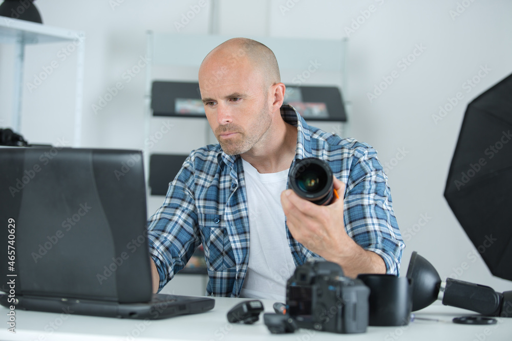 professional male photographer with digital photo camera in photo studio professional male photographer with digital photo camera in photo studio