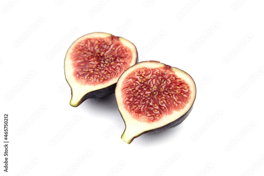 Halves of ripe fig fruit isolated on white