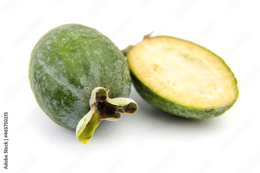 Feijoa fruit or whole and half pineapple guava isolated on white Feijoa fruit or whole and half pineapple guava isolated on white