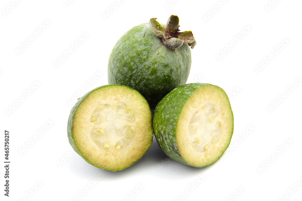 Feijoa fruit or whole and half pineapple guava isolated on white Feijoa fruit or whole and half pineapple guava isolated on white
