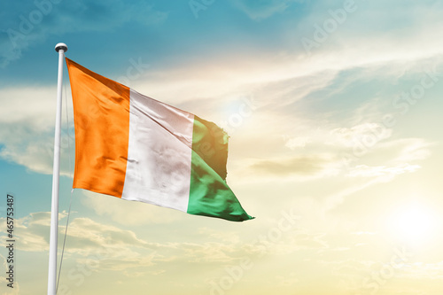 Cote d Ivoire national flag cloth fabric waving on the sky - Image