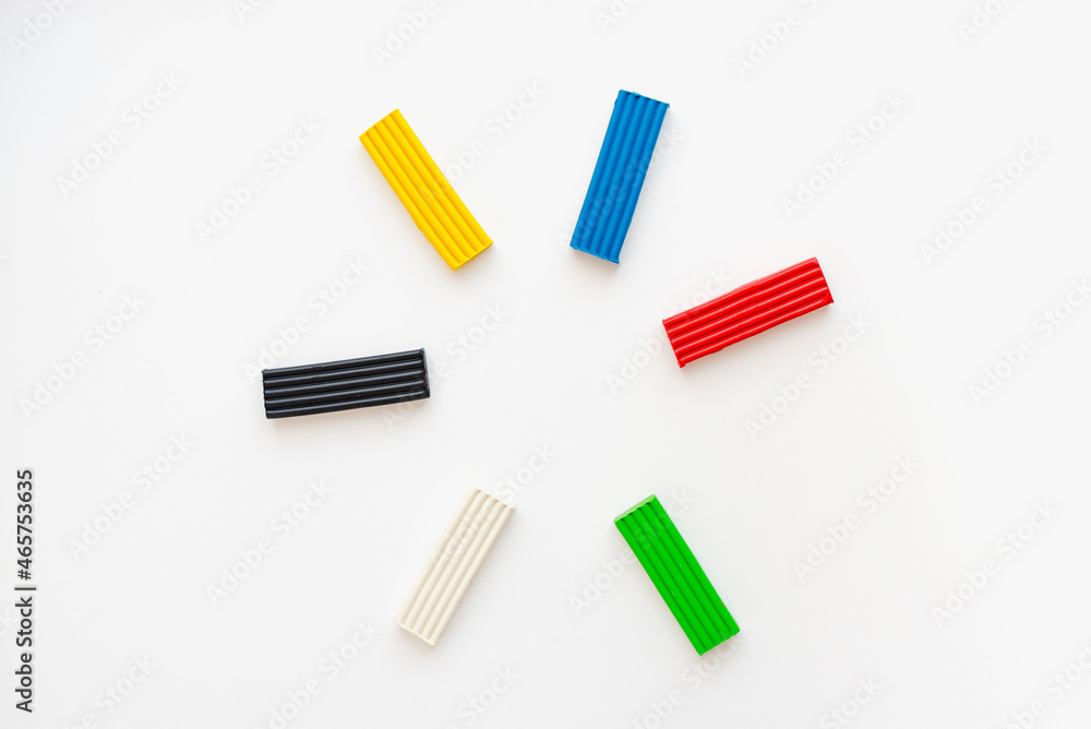Colored plasticine on a white background. Pieces of plasticine. Colored plasticine on a white background. Pieces of plasticine.