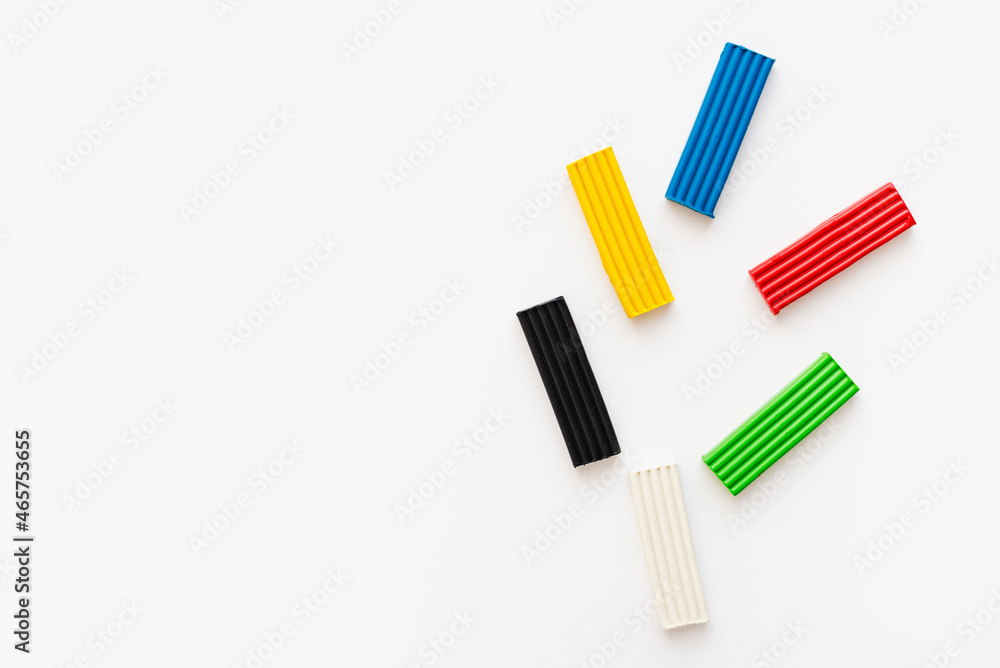 Colored plasticine on a white background. Pieces of plasticine. Colored plasticine on a white background. Pieces of plasticine.