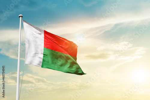 Madagascar national flag cloth fabric waving on the sky - Image