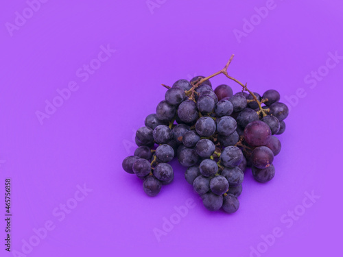 Red and white grapes, purple background. Top view, vintage,wine concept