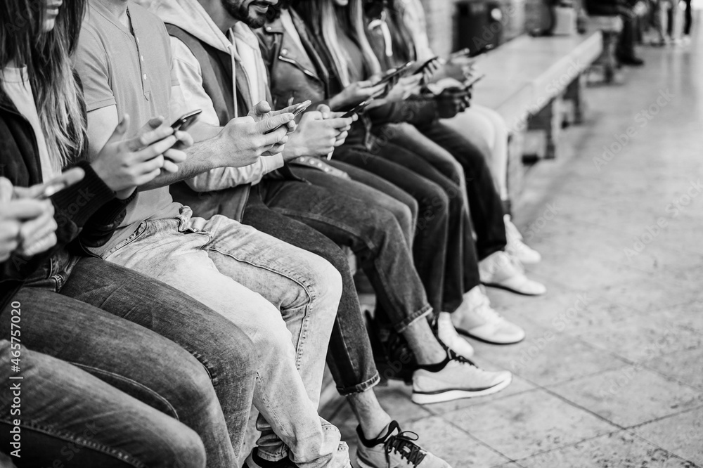 Naklejka premium Young happy people using mobile phones outdoor - Technology addiction concept