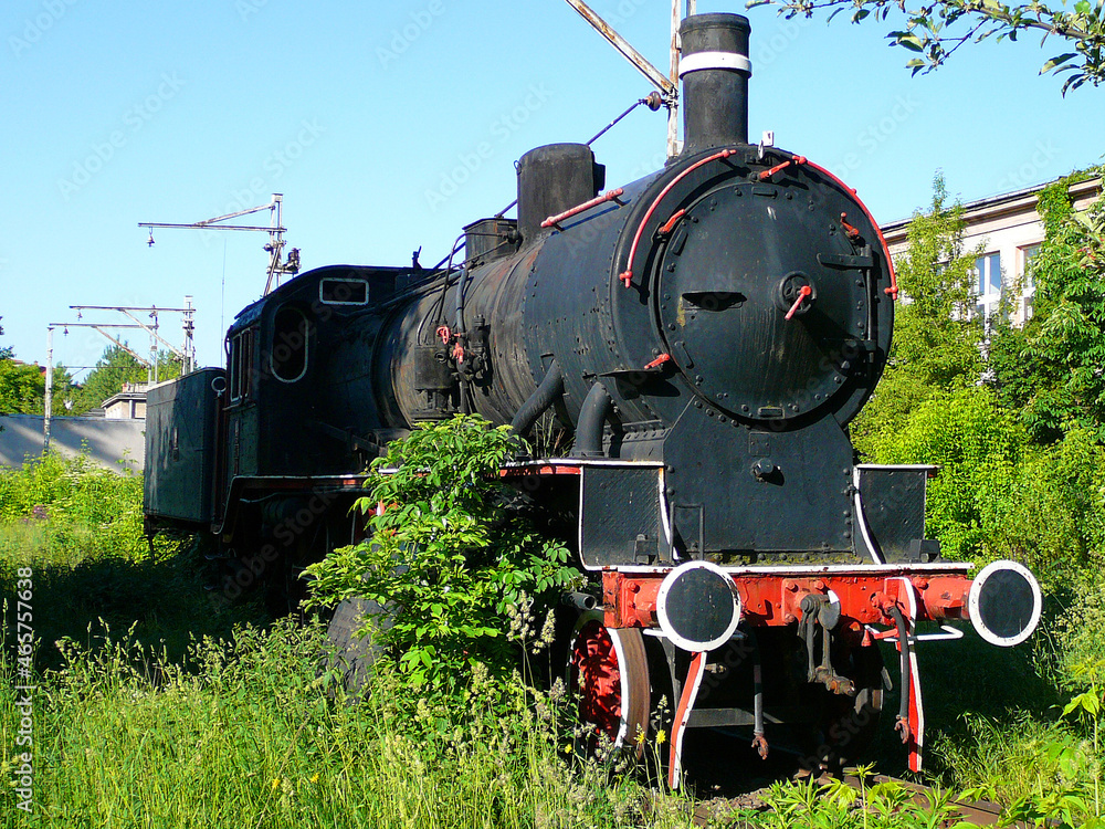 Naklejka premium an old locomotive standing in the locomotive shed
