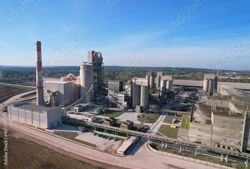 Cement plant with pipes.   ement production process and Industrial solution. factory with smoke pipe. Chimney smokestack emission. Poor environment. Ecology concept  air and environmental pollution.