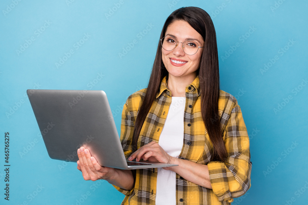 Photo of mature business woman happy positive smile use laptop agent isolated over blue color background Photo of mature business woman happy positive smile use laptop agent isolated over blue color background