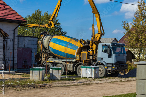 street lighting. the truck is pouring concrete. a private house is being built