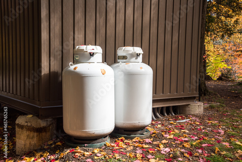 Tableau sur toile Propane cylinders outside a metal hut in a park in autumn