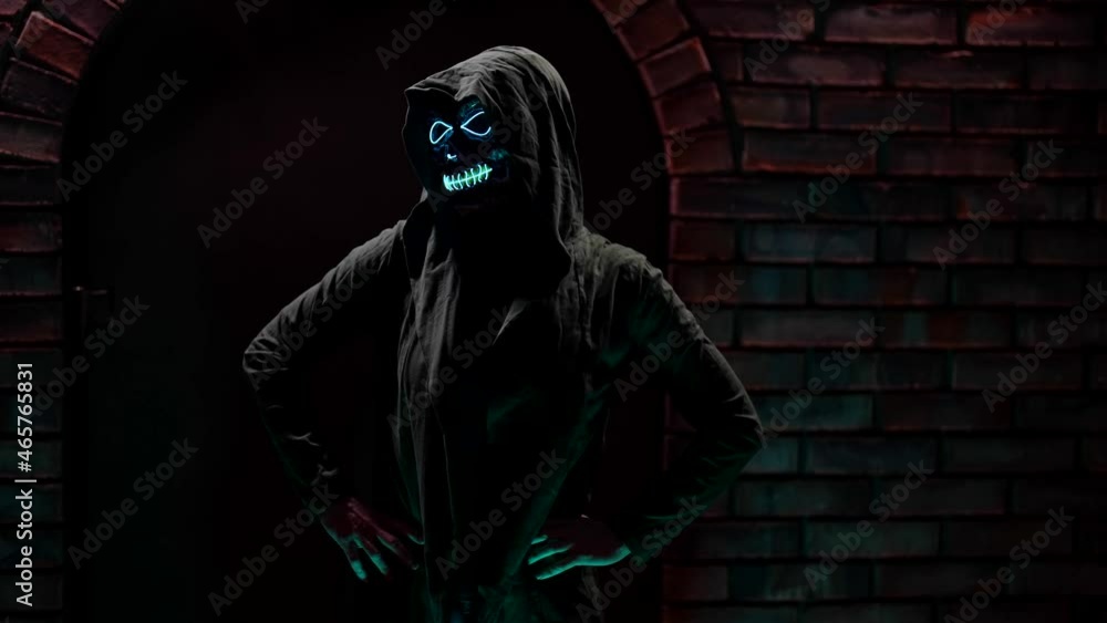 Halloween celebration portrait of death of a woman on the background of a brick castle in the dark Halloween celebration portrait of death of a woman on the background of a brick castle in the dark
