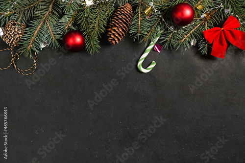 Christmas background with fir tree and decor. Christmas holidays composition on dark background. Flat lay. Nature New Year concept. Top view with copy space
