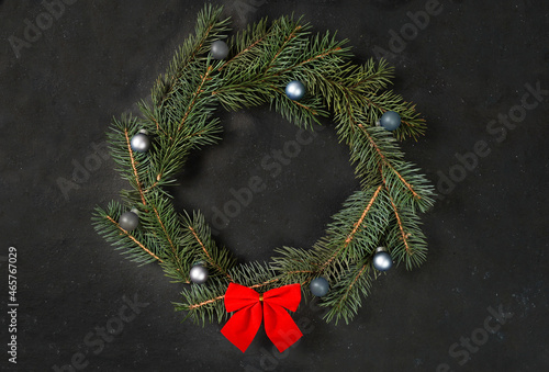 Beautiful Christmas wreath on dark background, top view. Space for text Christmas holidays composition. Flat lay. Nature New Year concept. Top view with copy space