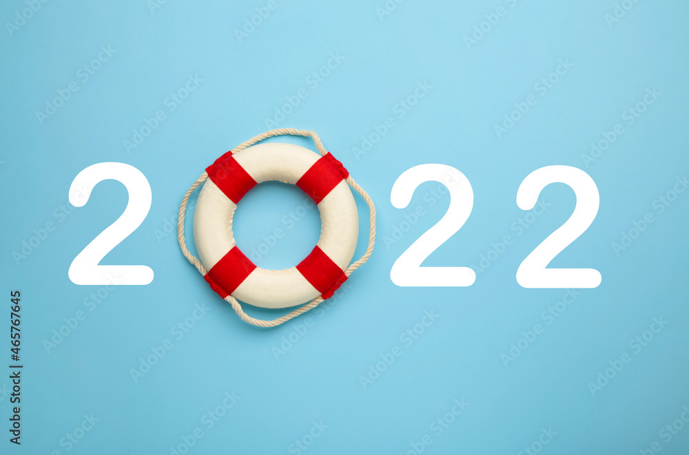 Happy new year 2022. Happiness and travel summer destination concept. Number 2022 with lifebuoy on blue Happy new year 2022. Happiness and travel summer destination concept. Number 2022 with lifebuoy on blue