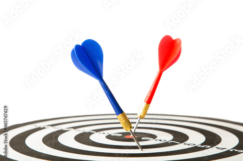 Close up shot red dart arrow on center of dartboard isolated on white, metaphor to target success, winner concept.