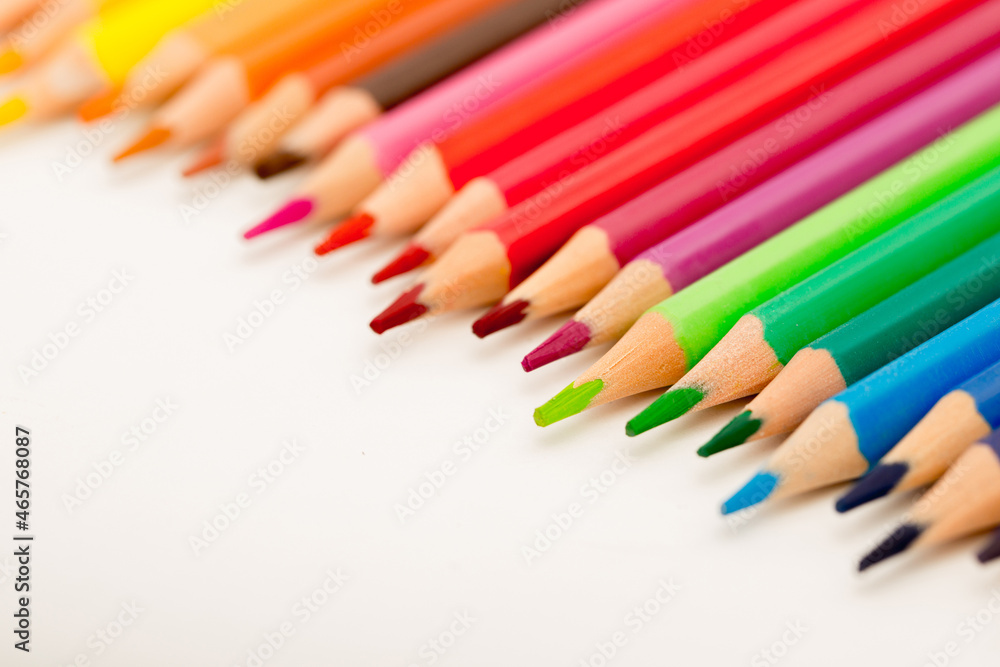 School stationery items. Creation Multicolored pencils on a blank white sheet. On a white background. Children's drawing, artist. School stationery items. Creation Multicolored pencils on a blank white sheet. On a white background. Children's drawing, artist.