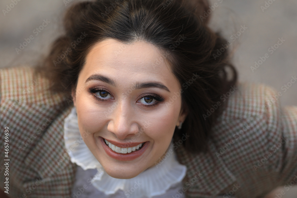 portrait of beautiful smiling woman outdoors, top view portrait of beautiful smiling woman outdoors, top view