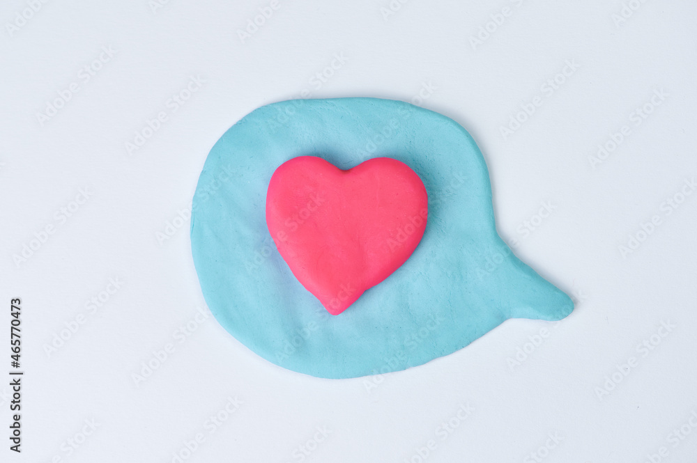 blue speech bubble on white background, in the center there is a pink heart as a sign of love blue speech bubble on white background, in the center there is a pink heart as a sign of love