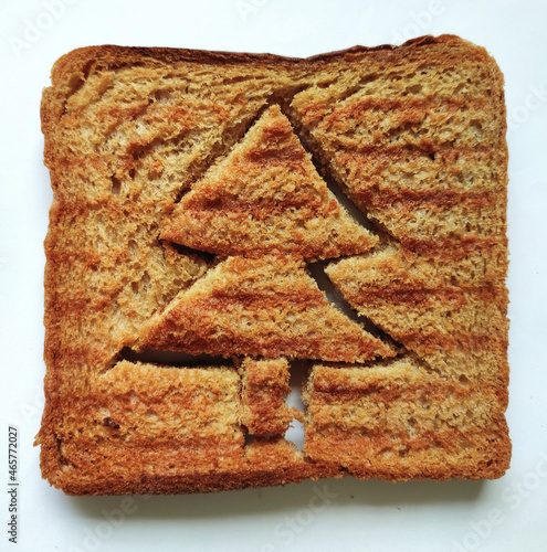Concept of Christmas morning breakfast meal. Funny christmas tree toasted brown bread for kids. Fun food for kids toasted brown bread for festive breakfast on Christmas photo
