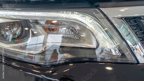 Close-up element of reflector of new car headlight headlight. Car background with soft focus. photo