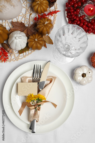 Beautiful autumn place setting with blank card and decor for festive dinner on table, flat lay