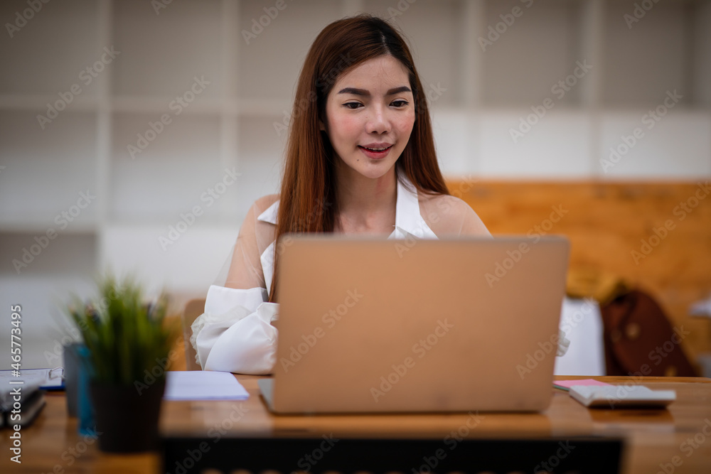 Portrait of a beautiful young business Asian female entrepreneur working in modern office, doing finances, accounting analysis, report, data, and pointing graph. Portrait of a beautiful young business Asian female entrepreneur working in modern office, doing finances, accounting analysis, report, data, and pointing graph.