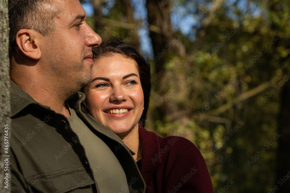 Beautiful young couple in autumn forest on a sunny day Beautiful young couple in autumn forest on a sunny day
