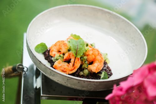 Black risotto with roasted shrimps