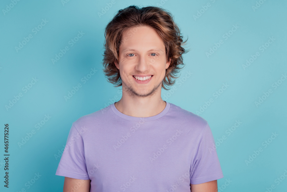 Photo of young cheerful guy happy positive toothy smile oral care whitening isolated over teal color background Photo of young cheerful guy happy positive toothy smile oral care whitening isolated over teal color background