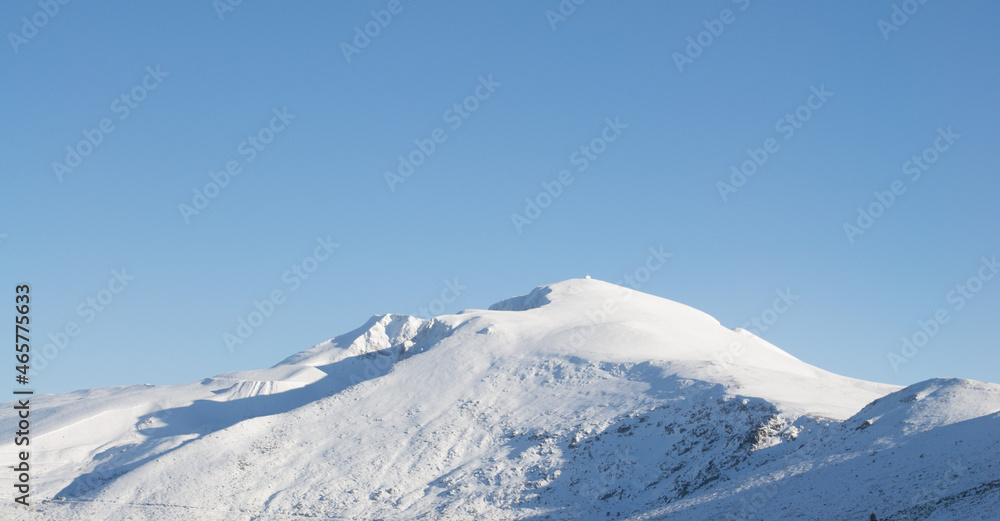 Snow-capped mountain peaks on a sunny day. background for winter sports and winter holidays