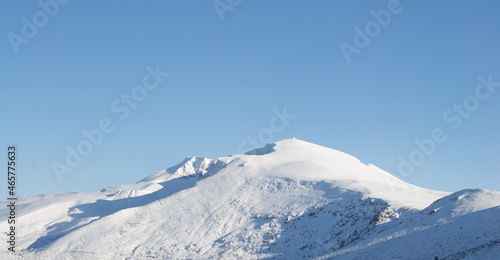 Snow-capped mountain peaks on a sunny day. background for winter sports and winter holidays © Ali