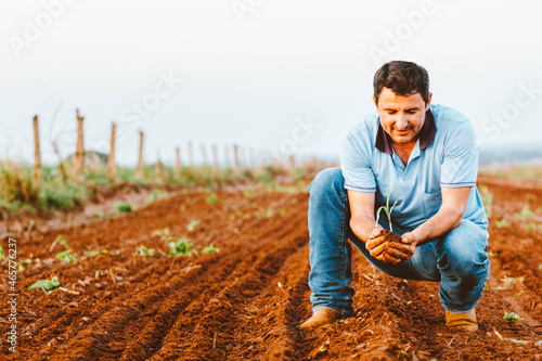 In this photo illustration the farmer holds a corn plant in the field. Agriculture is one of the main bases of the Brazilian economy.