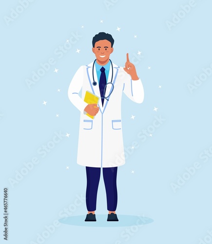 Doctor standing with pointing up with his forefinger. Happy smiling physician in medical gown showing finger up. Male character in white coat with phonendoscope, folder in hand. Vector illustration