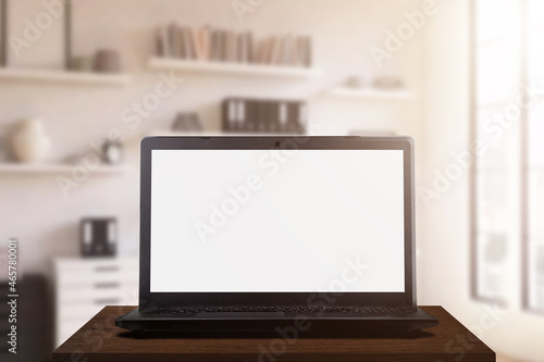 Notebook computer on a wooden table in the office. with copy space