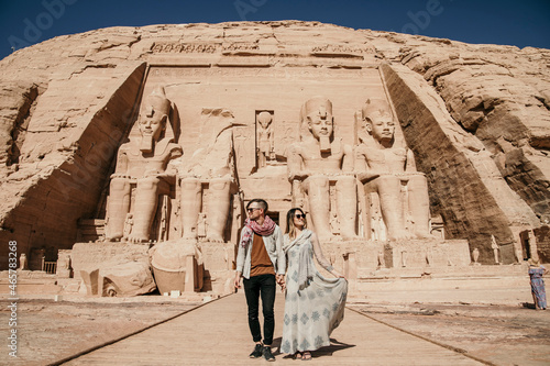 Traveling Couple exploring Abu Simbel ancient temple in Egypt