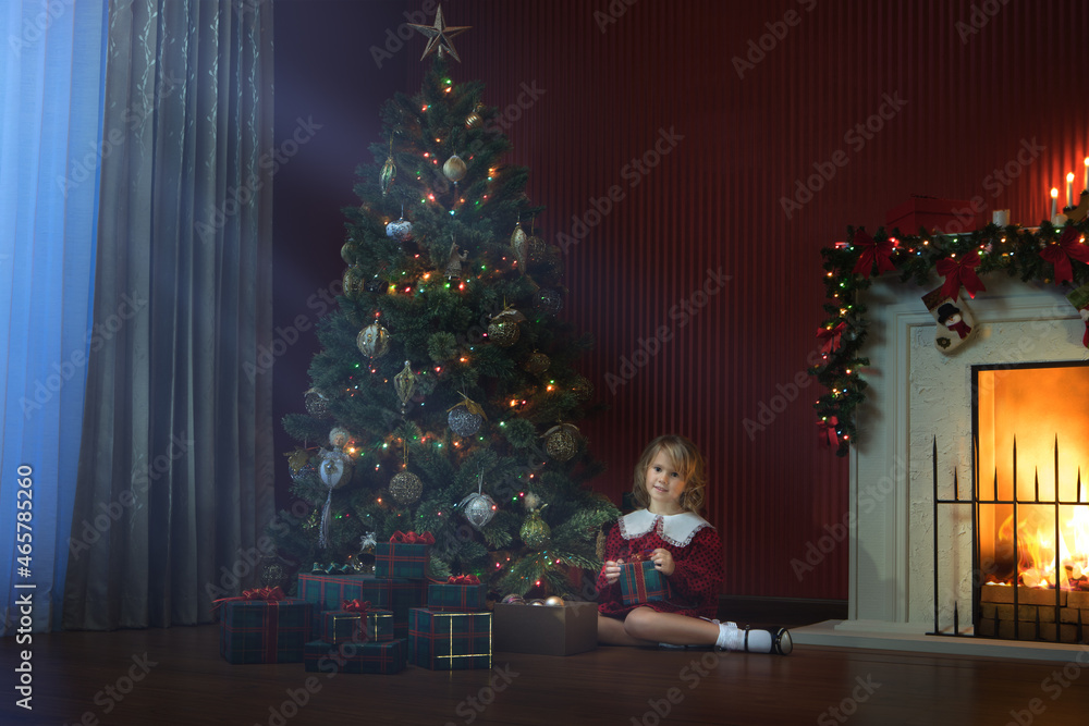 portrait of little girl with gift box in  christmas domestic environment