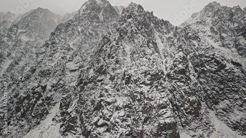 Storm, snowfall in the huge glacier of Mount Belukha, the valley of the Aktru River, the Altai Mountains. Cloudy weather, stone in the snow, storm, wildlife, winter forest, frozen mountain river in