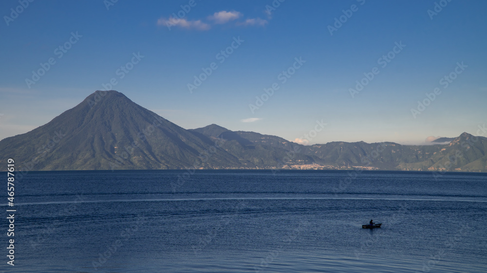 Panoramic view of a local fisherman on Lake Atitlan in Panajachel, Guatemala at sunrise