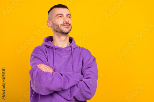 Portrait of attractive dreamy content cheerful guy folded arms thinking copy space isolated over vivid yellow color background