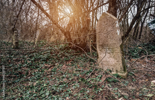 An old Christian gravestone in a very old abandoned cemetery.