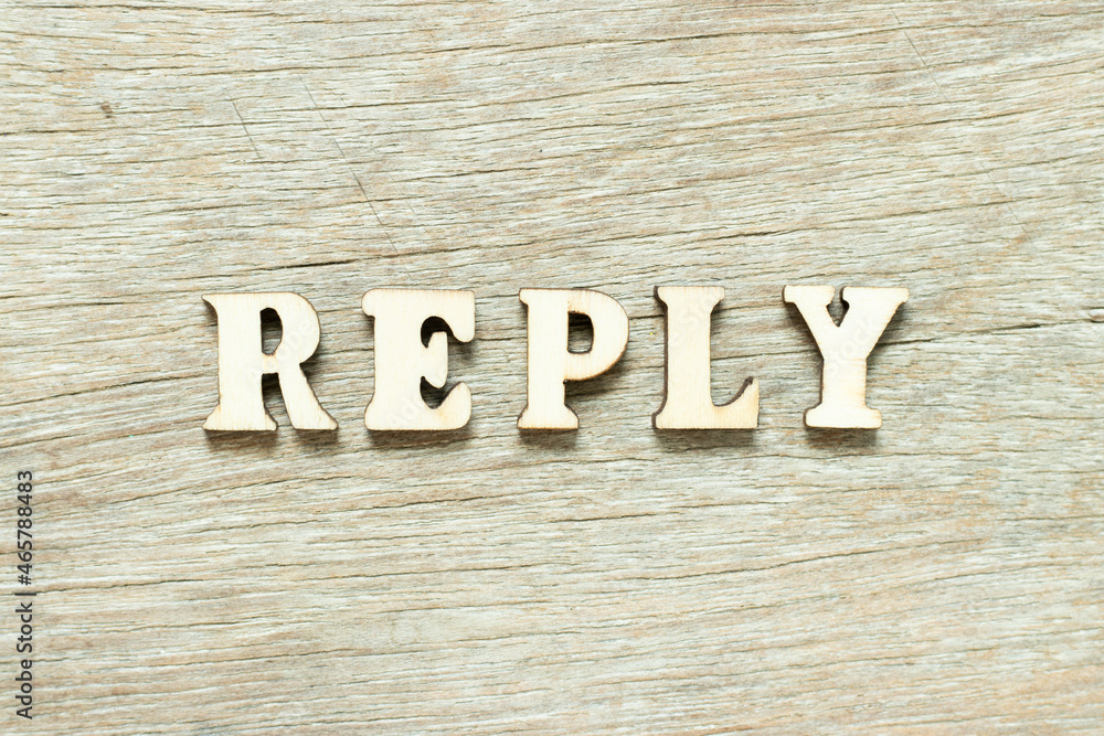 Alphabet letter in word reply on wood background Alphabet letter in word reply on wood background