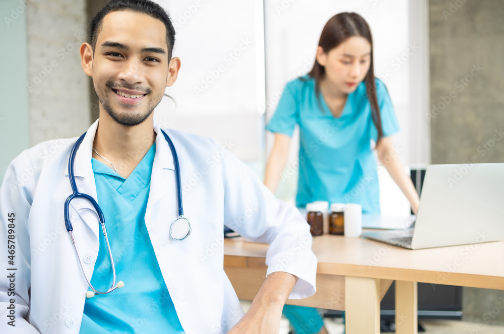 Confident young Asia female doctor in white medical uniform with stethoscope looking at camera and smiling while video conference call with patient in health hospital. Confident young Asia female doctor in white medical uniform with stethoscope looking at camera and smiling while video conference call with patient in health hospital.