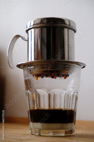 Making coffee in a Vietnamese phin with condensed milk in a glass photo