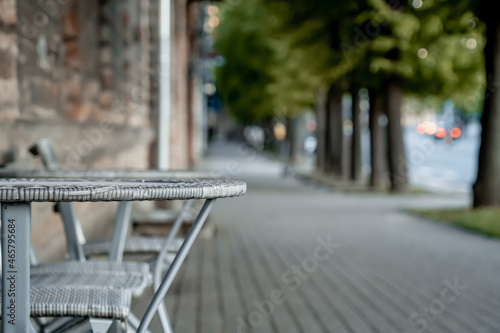 Wicker table of a cafe on the street in summer. Blurred background (1101) © Maayan