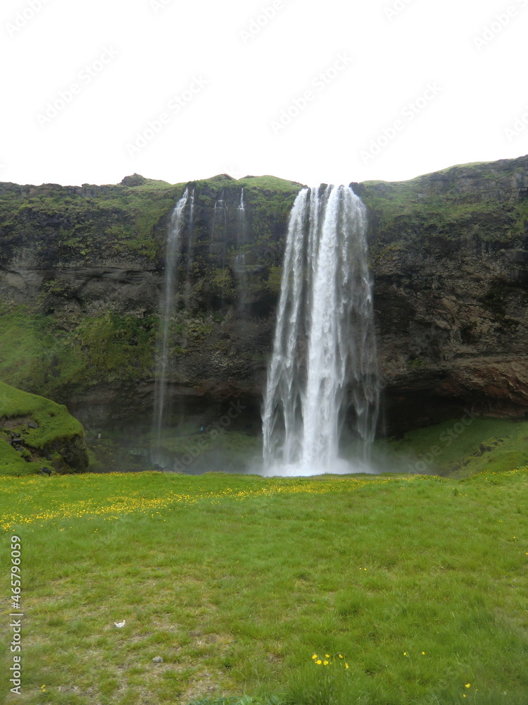 At the foot of the waterfall in Seljalandsfoss, Iceland At the foot of the waterfall in Seljalandsfoss, Iceland