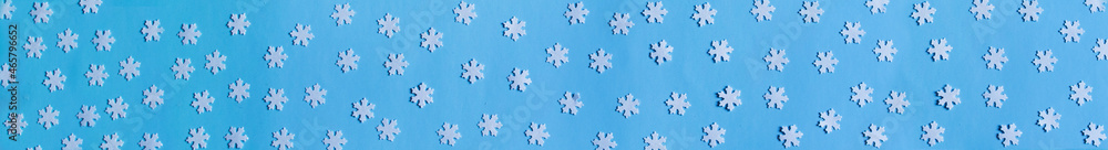 Winter background. Long banner. Blue background with white snowflakes. Christmas new year