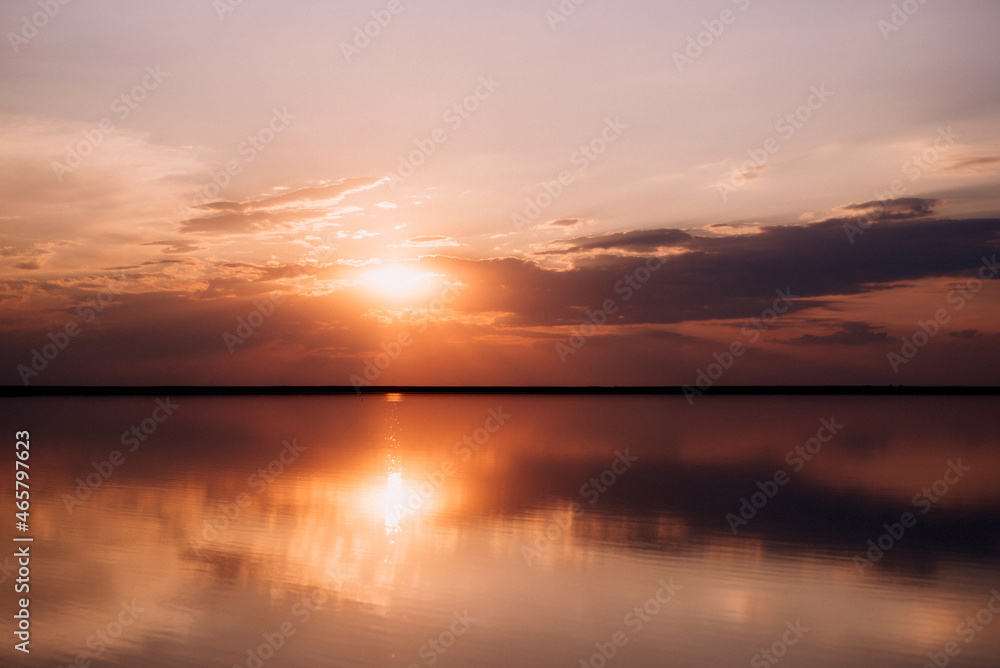 sunset on the shore of a pink lake