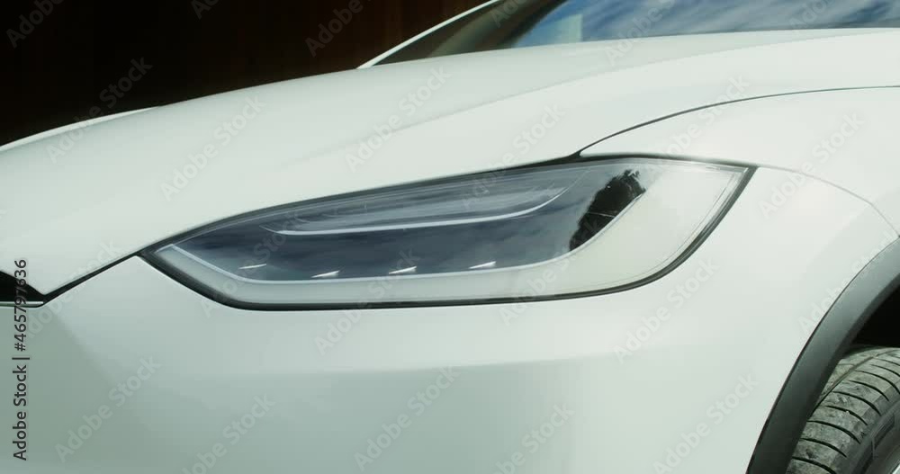 Headlight of white electric car close up Headlight of white electric car close up