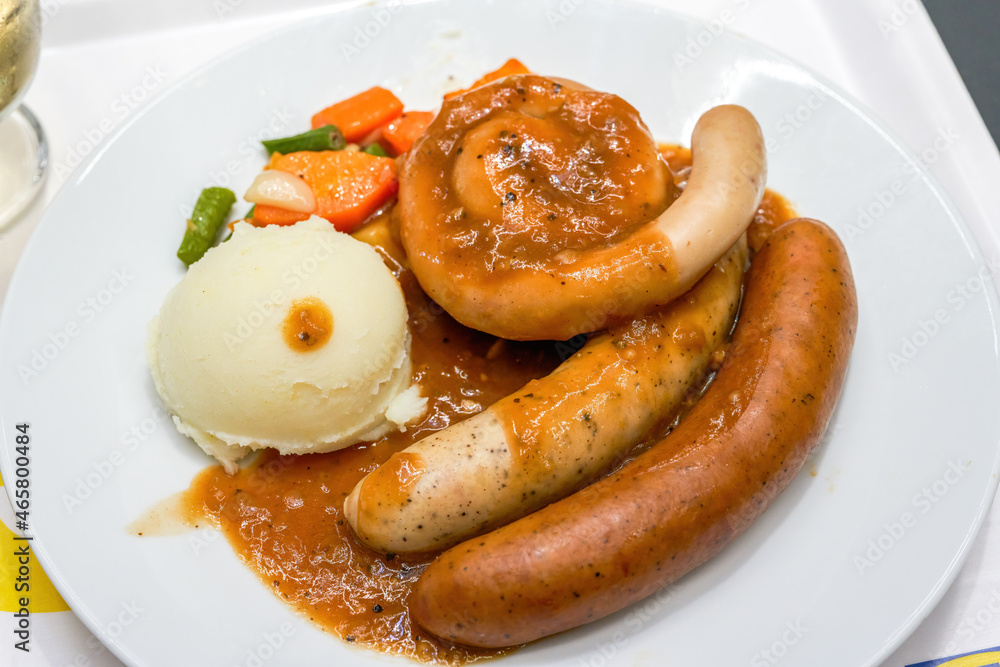 A delicious German meat sausage platter with mashed potatoes A delicious German meat sausage platter with mashed potatoes